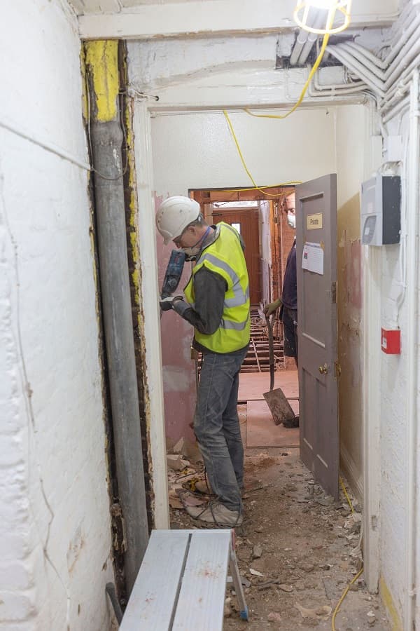 Removing old pipework and wiring in the corridor