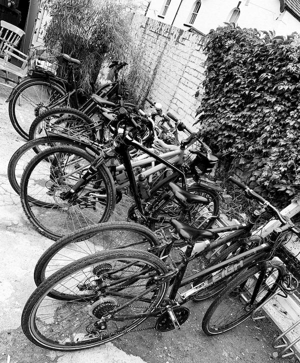 Cycles parked up next to the front wall