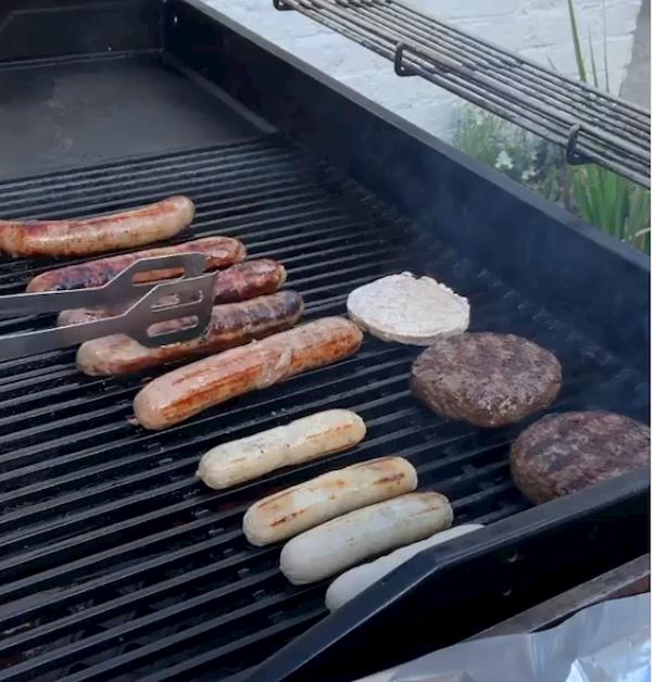 Burgers and sausages being cooked on the barbie