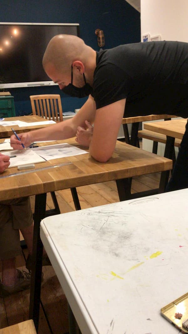 Professional artist helping one of the class