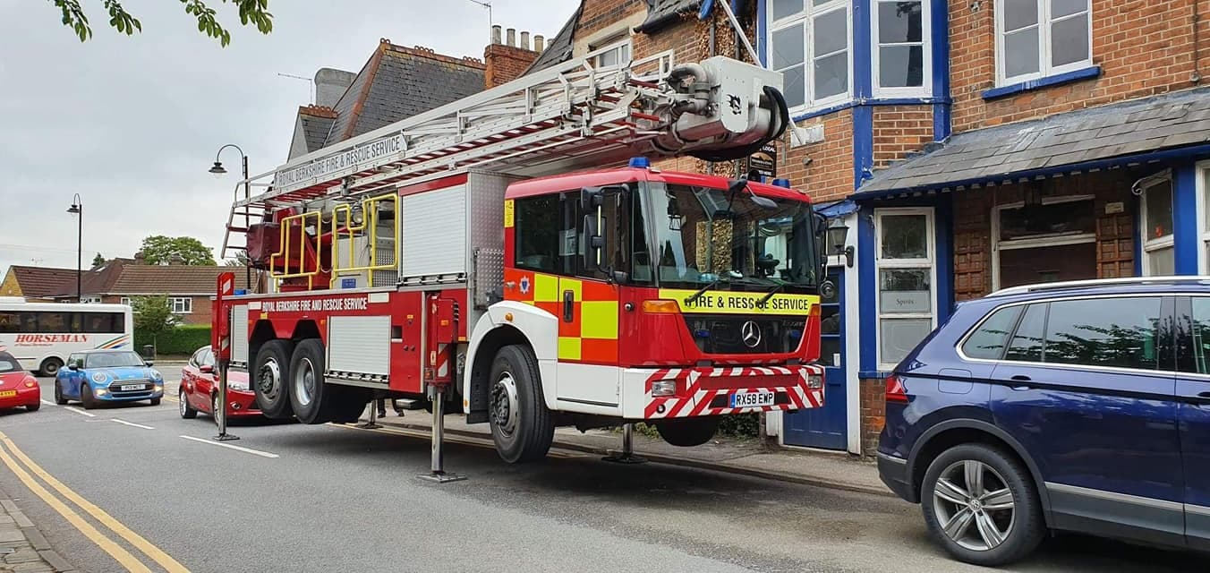 Fire engine slotted in between parked cars