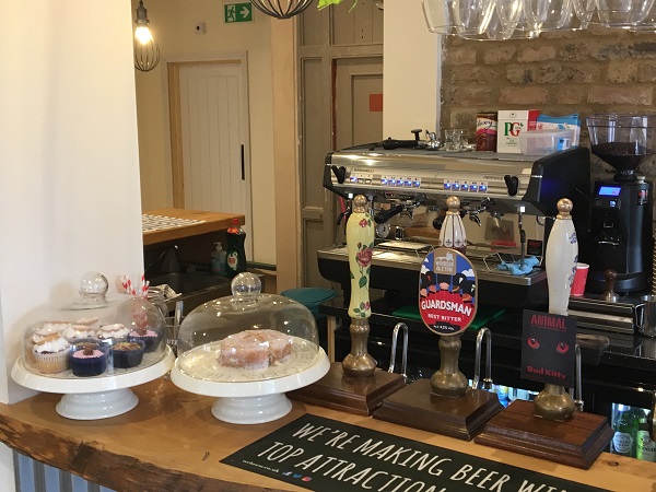 New coffee machine and cakes stand filled with goodies