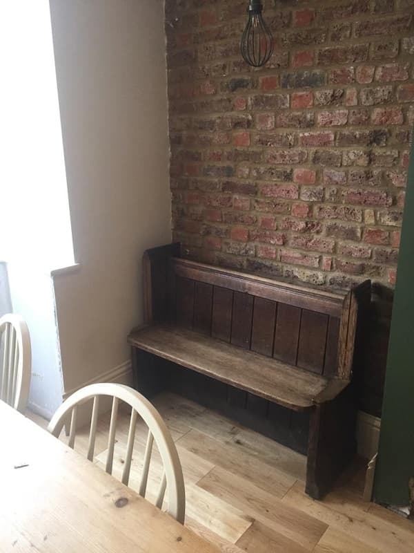 Old fashioned pew fitted into one of the alcoves