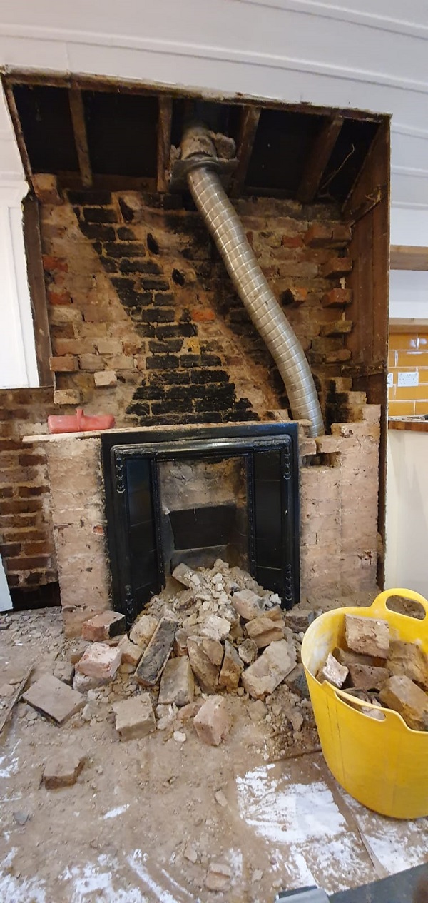 Chimney breast being removed in school room