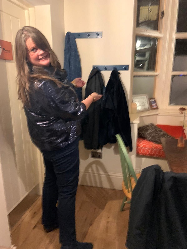 Louise demonstrating how to use the new coat hooks