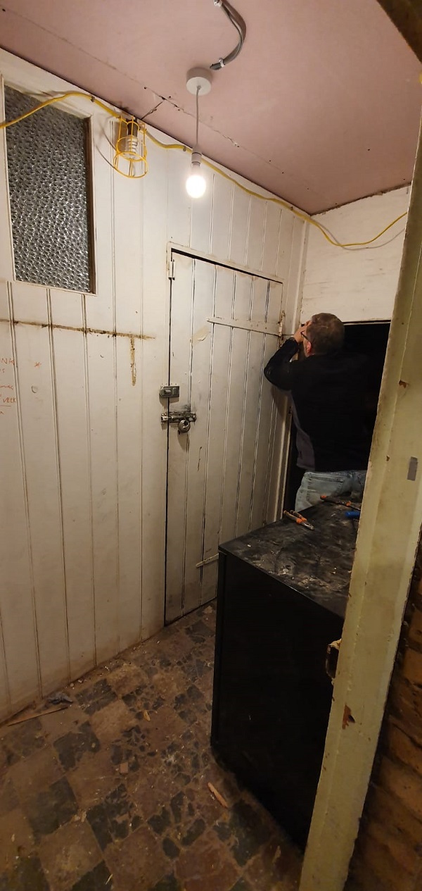 Trevor starting to remove partition wall within the stock room