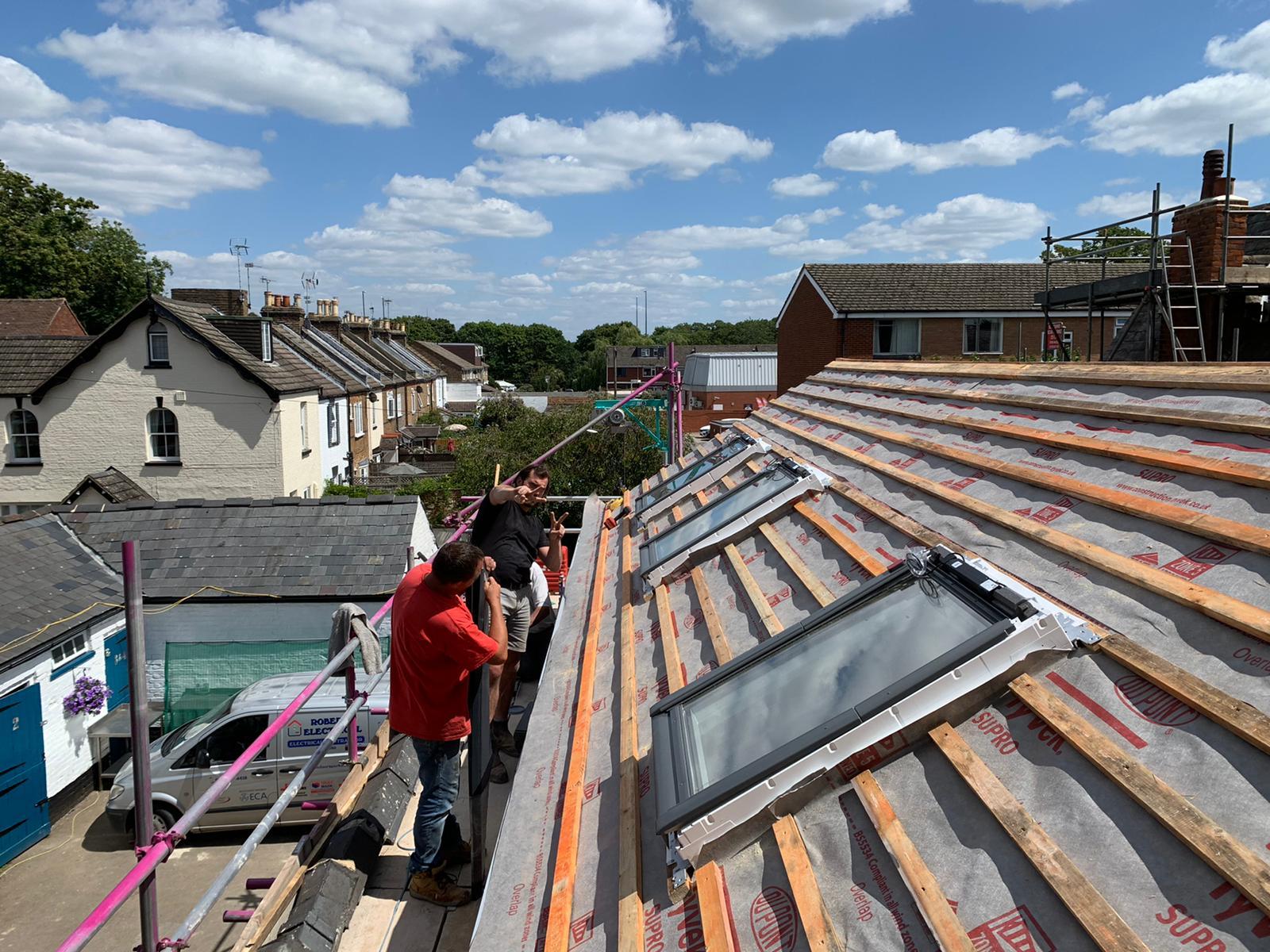 Coach House roof with the Jayflex team working in the velux windows