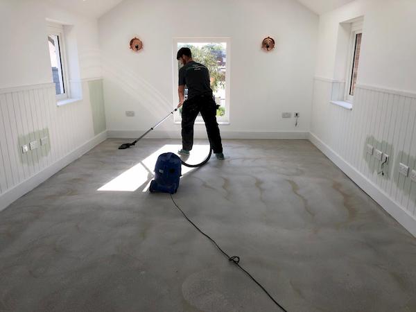 Hoovering the fllor before laying the wooden floor
