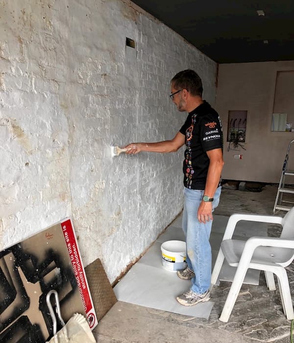 Trevor whitewashing walls