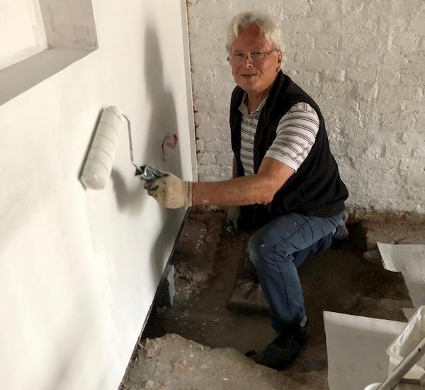 Jim whitewashing in the ground floor of The Coach House