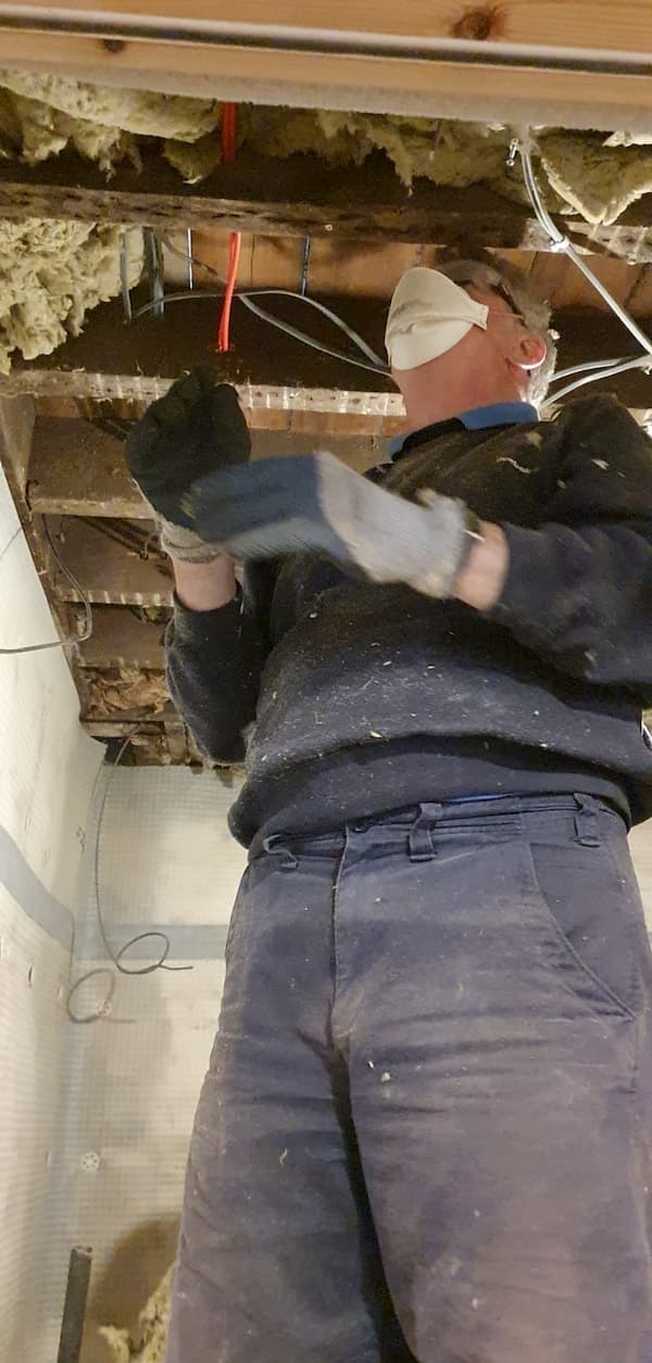 Richard putting in insulaton in The Kitchen ceiling