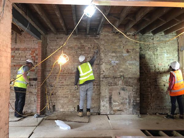 Volunteers removing last of the plaster in the bar