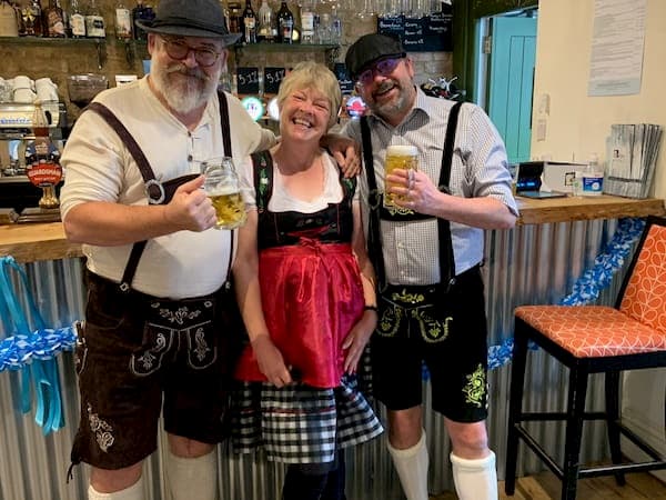 People dressed up in traditional German lederhosen and gear - Oktoberfest