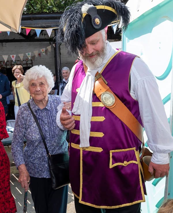 Chosen to receive the first drink from the re-opened pub