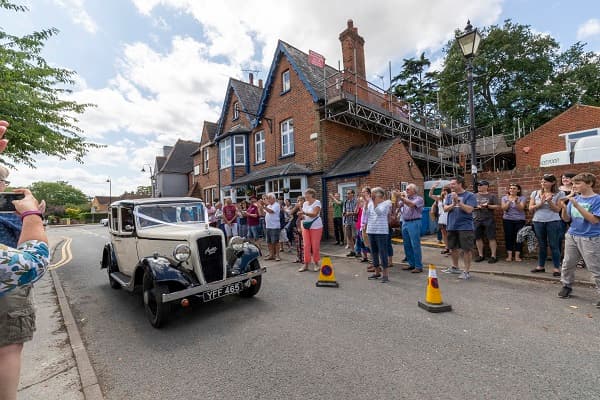 Bride arriving at Saint Andrews in a vintage car