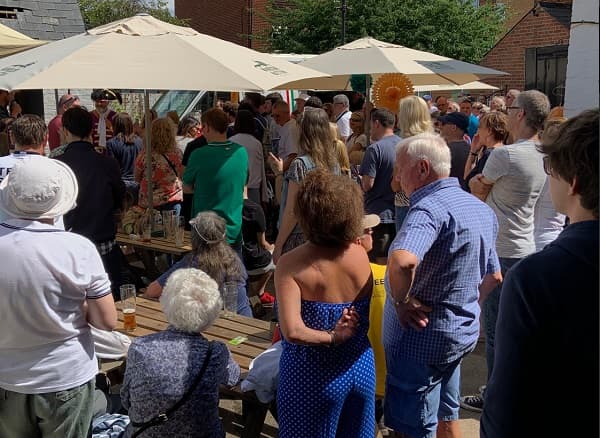 The busy courtyard listened intently to the speeches