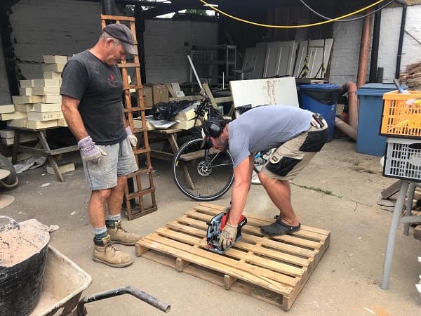 Father and son team making the temporary bar out of pallets