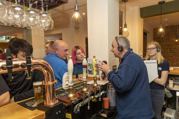 Phil talking from behind the bar