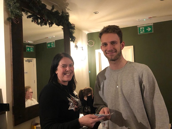 Being presented with his prize