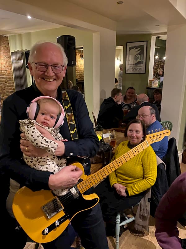 One of the guitarists with thei grandchild