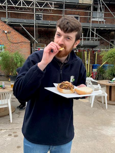 One of the bar staff enjoying a burger 