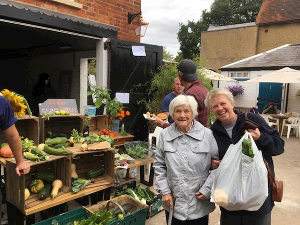 Got our vegetables and fruit - holding up a bag with the evidence