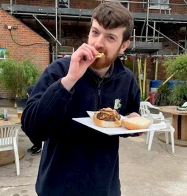 Luke from the bar team enjoying a burger