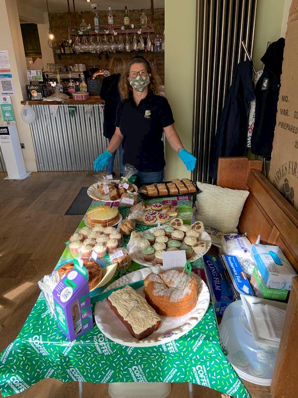 Rachel with the table of cakes