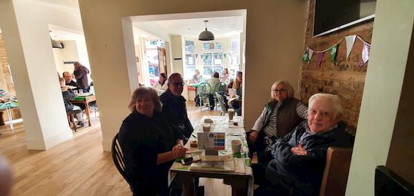 Table of old faces enjoying their cake