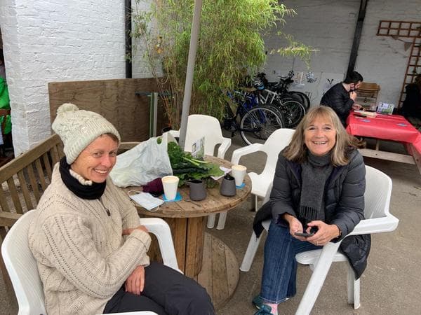 People sitting in the window enjoying the cofee and cake