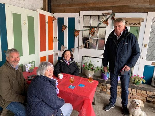 People sitting in the window enjoying the cofee and cake