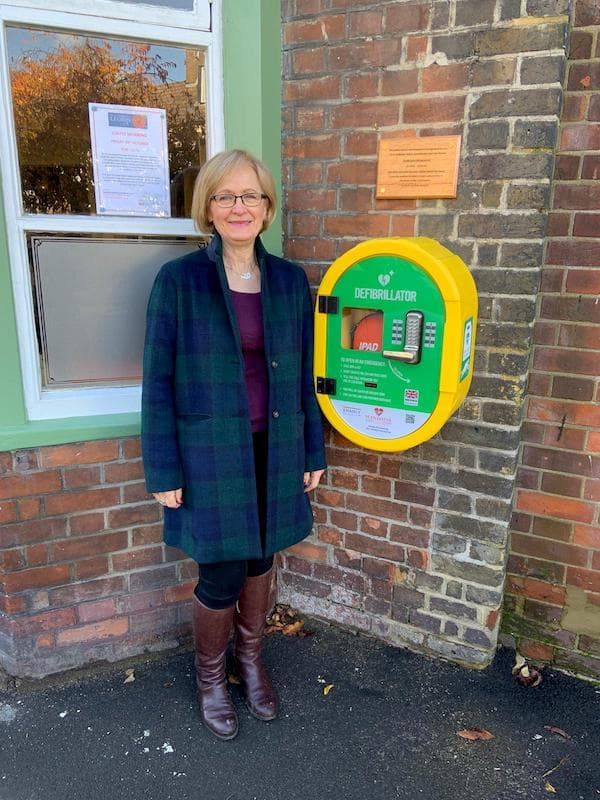 Dawn beside the defib which was an idea of Adrian for which she paid for the installation.