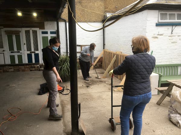 Clearing away the debris under the covered area