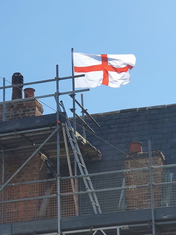 Flag flying from the very top of the scaffolding