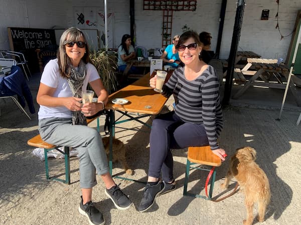 Two ladies and their wee dog enjoying the sun