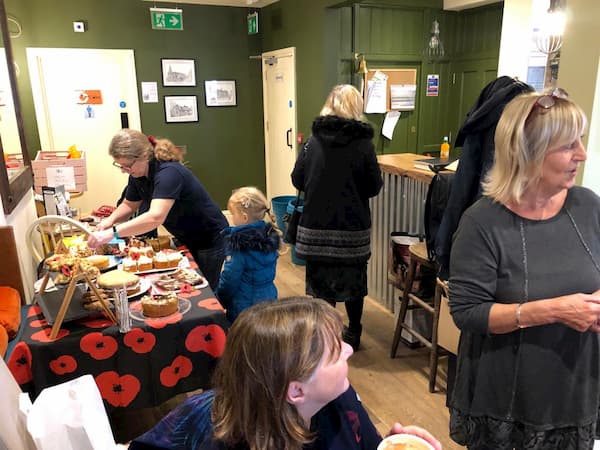 Rachel helping a young girl to some cake