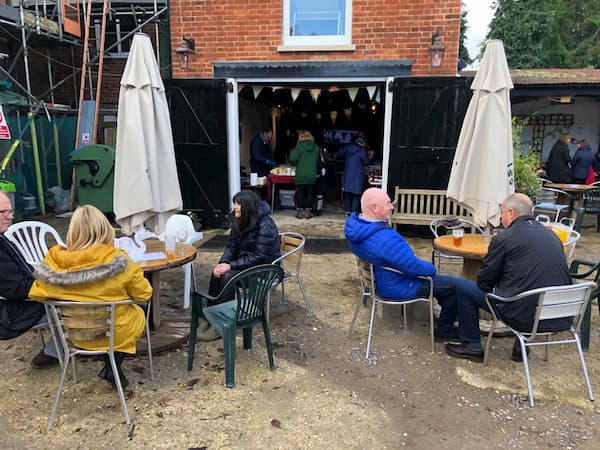 People sitting in The Courtyard - wrapped up warm of course!