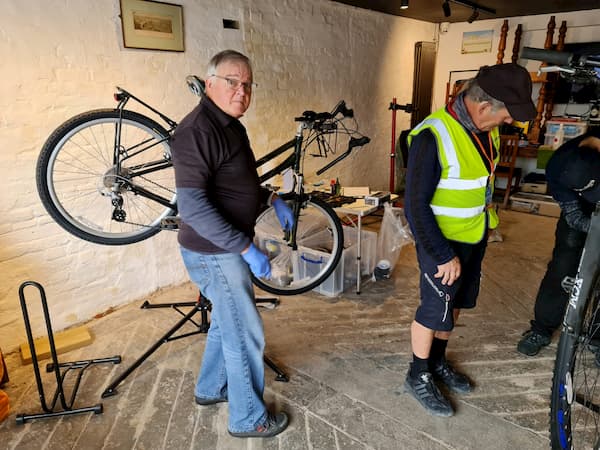 Working on a bike in The Coach House