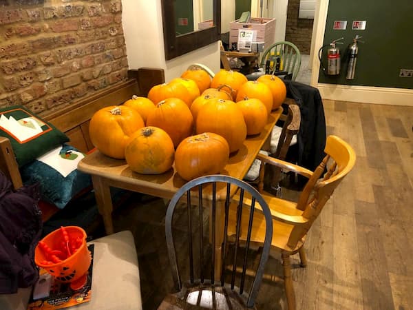 Table full of pumpkins ready for carving
