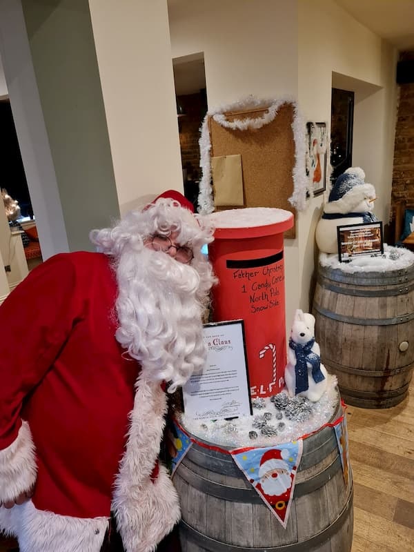 Santa next to his postbox for children