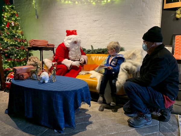 Wee boy sitting in awe of Santa