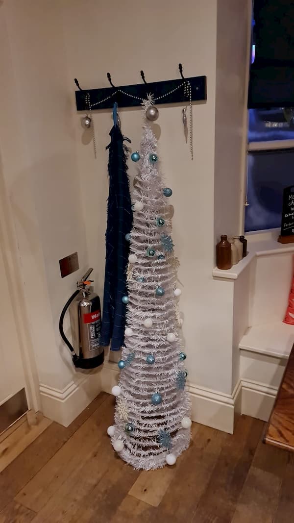 Silver Christmas tree next to the ladies loo