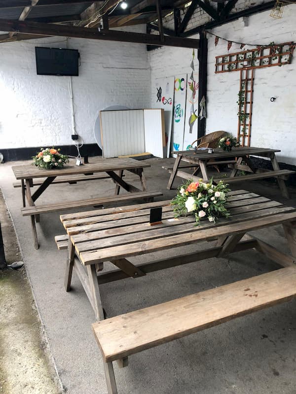 Under the shed looking cleared and with flowers