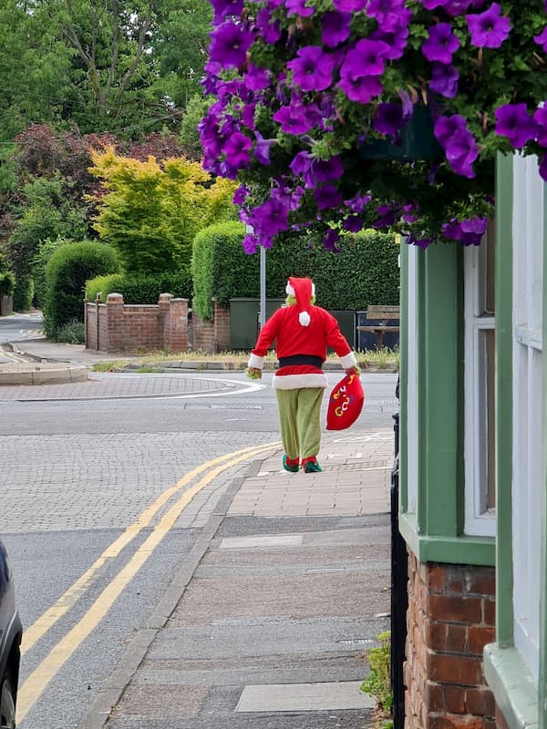 The Grinch walking away from the pub towards the roundabout