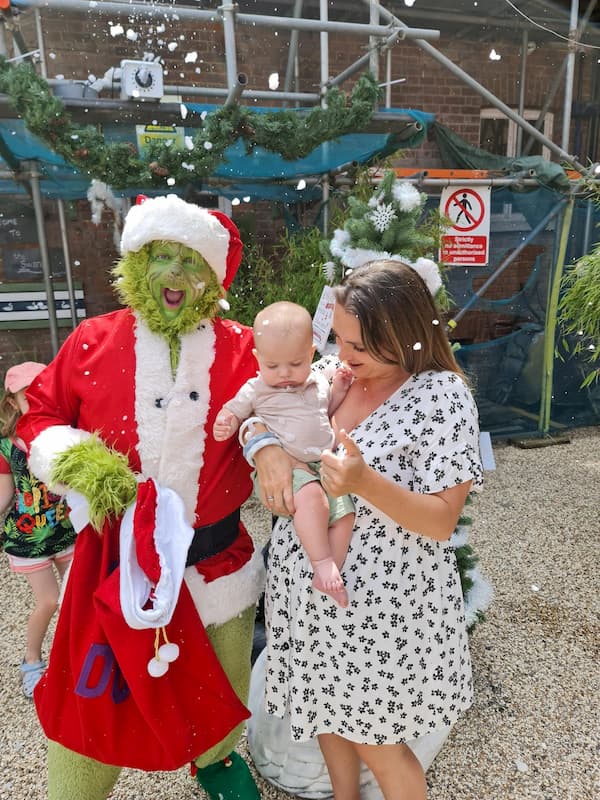 A baby doesn't look that phased by The Grinch