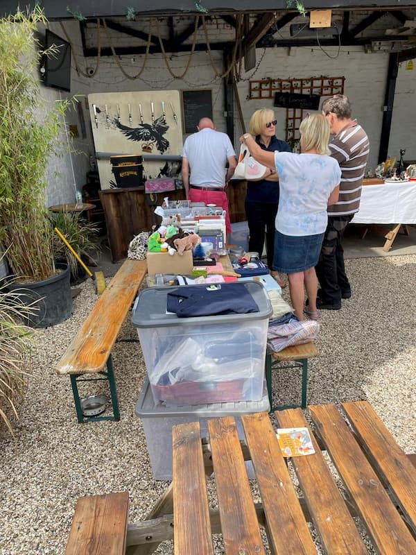 Potential customers looking at the bric-a-brac stall