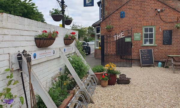 Hanging baskets on the front wall of The Courtyard