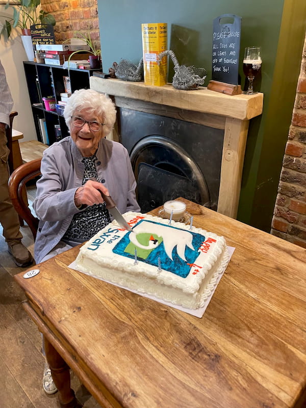 Rene - at 101 our oldest regular - cutting the birthday cake.