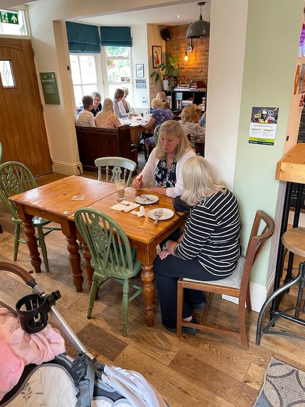 People having a chat over a coffee and cake.