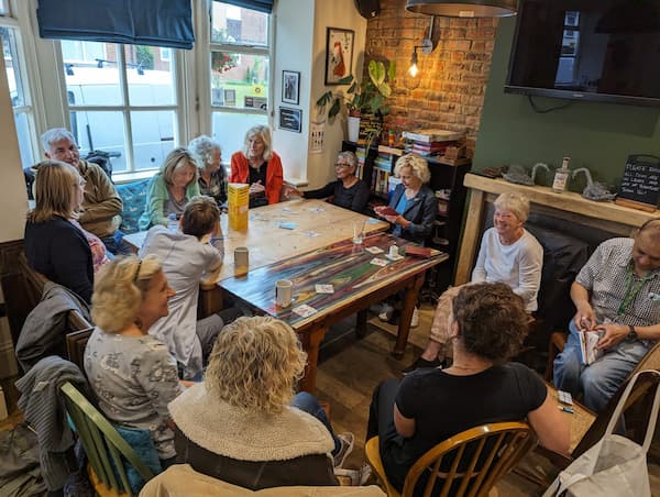 A very popular chatty cafe with extra tables being joined in